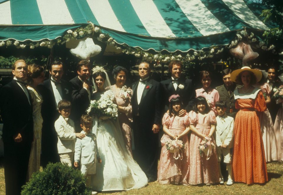  The singer and actress, centre in pink with The Godfather cast, sang Luna Mezzo Mare during one of the wedding scenes