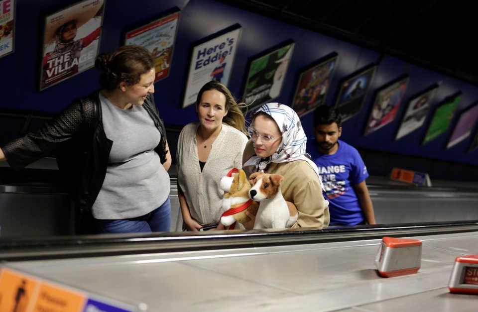 Is that Her Majesty? No, it’s our Lauren and her toy dog striding up the escalators