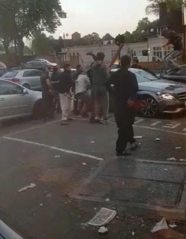  A battle outside a Birmingham takeaway sees dozens of hammer-wielding thugs in a bloody tear-up that leaves a Mercedes smashed up