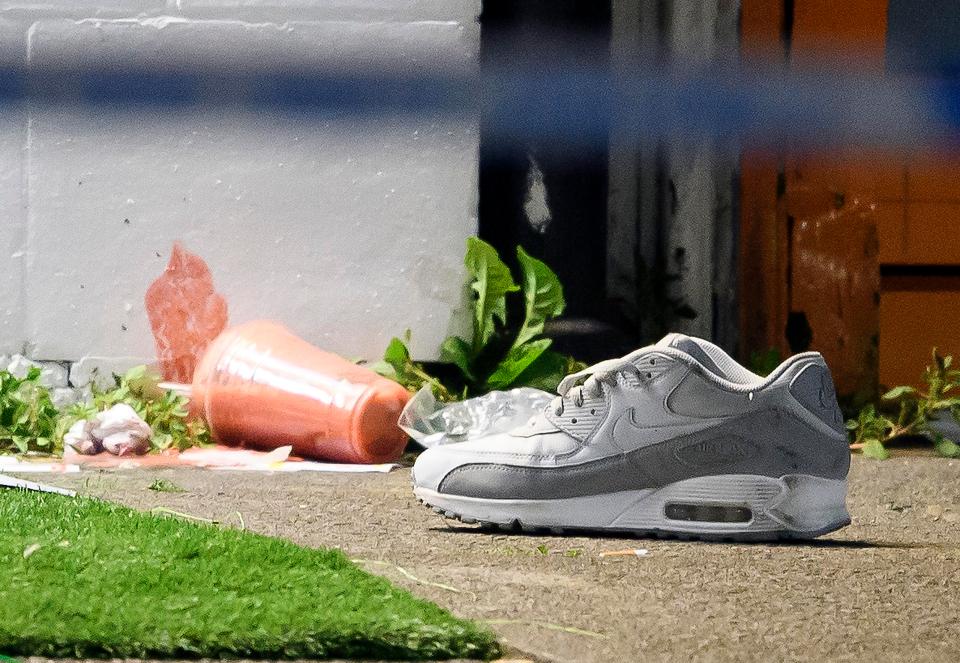  A shoe and a spilt drink lie at the scene of a shooting on Kingsbury Road