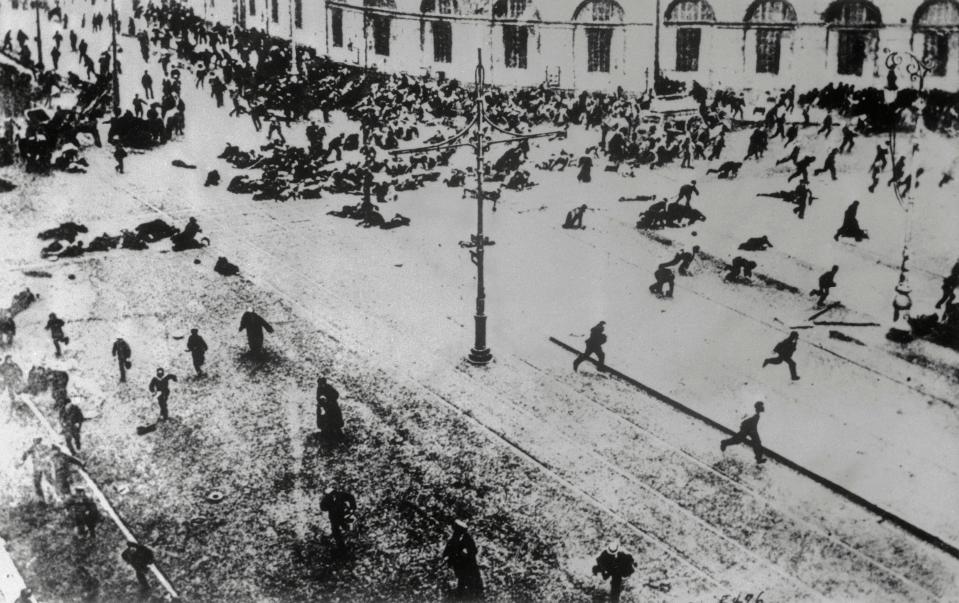  Petrograd residents flee Tsarist machine guns after a demonstration.