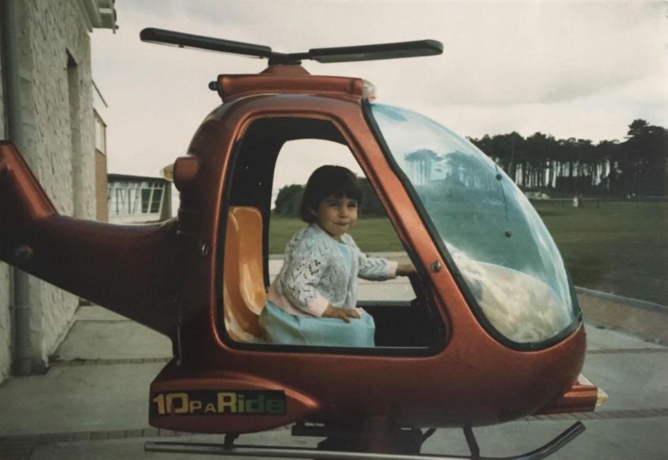  A very young Roxanne appears to enjoy the high life as she rides a kiddies' helicopter