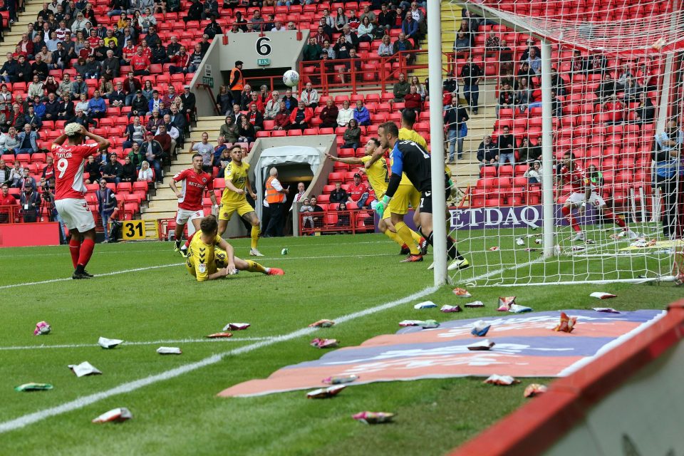  Charlton play on after fans threw crisp packets on the pitch at The Valley