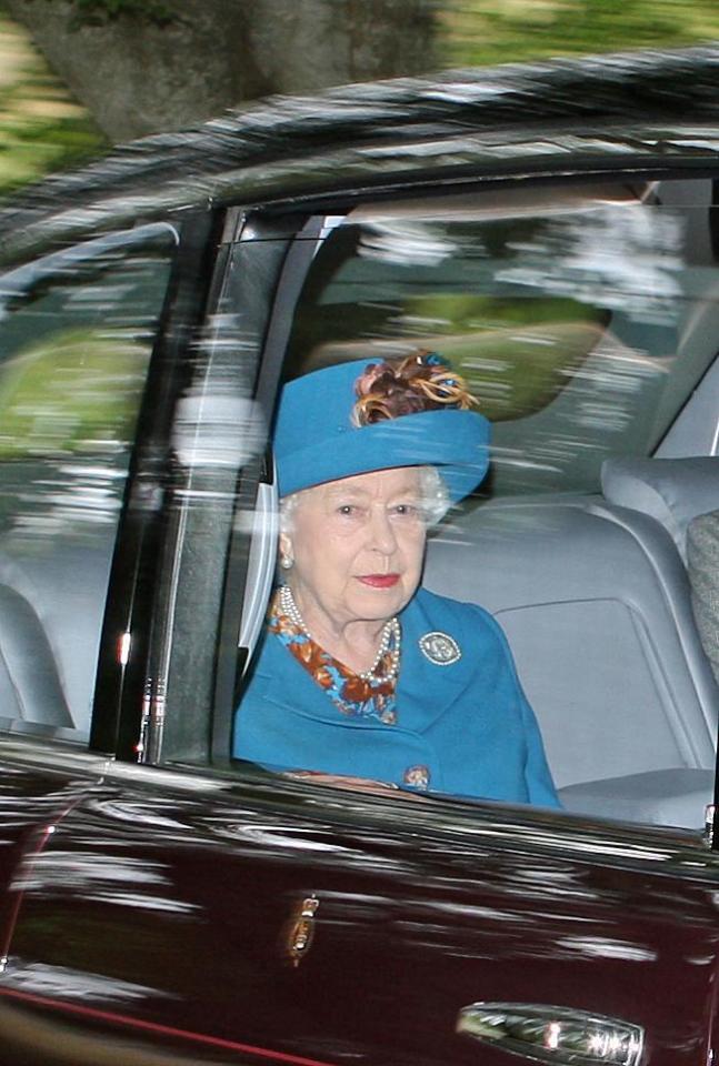  The Queen looks regal in a vibrant blue coat with a bronze floral collar and matching hat