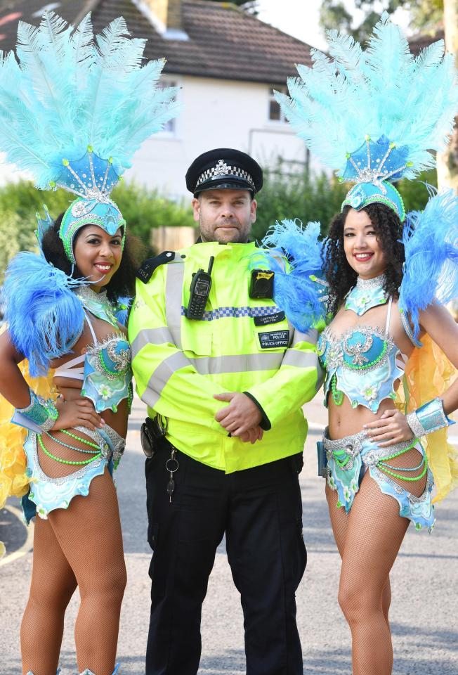  Another cop has a picture taken with two carnival dancers