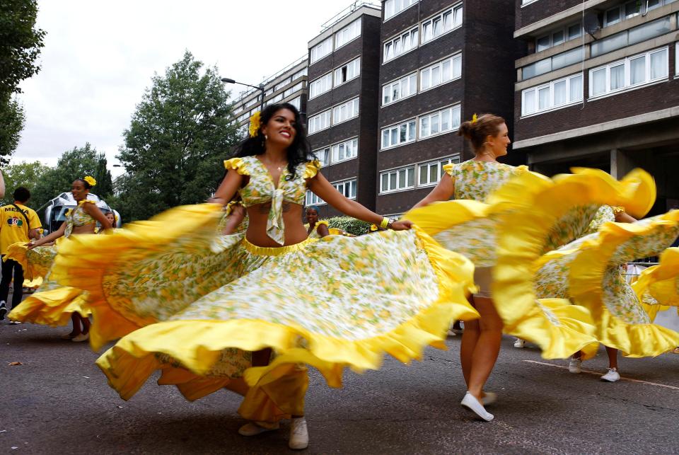  Performers twirl their long skirts as crowds line the streets