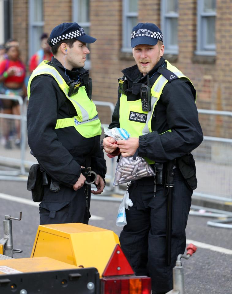  A cop carries laughing gas canisters