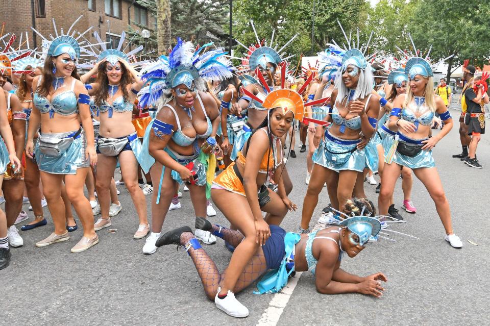  A dancer straddles a fellow performer