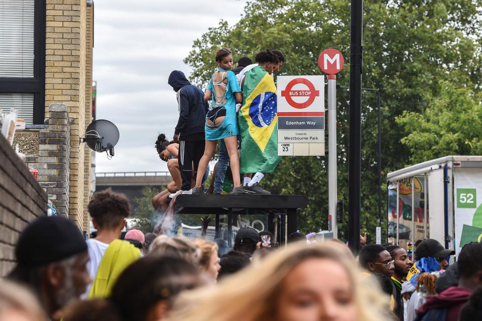  Revellers twerk on a bus stop as the festivities continue into the afternoon