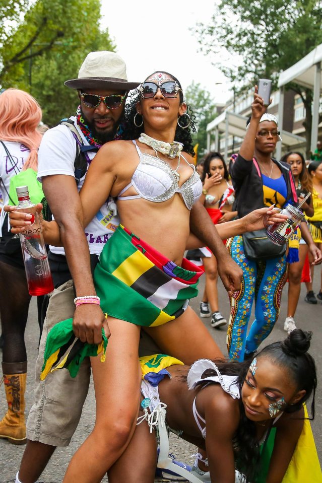  Two women dance on the street at the carnival