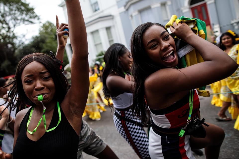  Revellers dance on the street as the parade made its way through Notting Hill