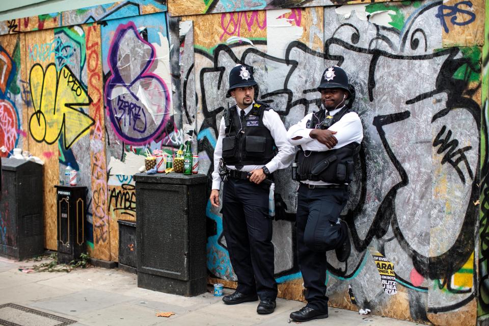  Police officers look on during the final day of the Notting Hill Carnival