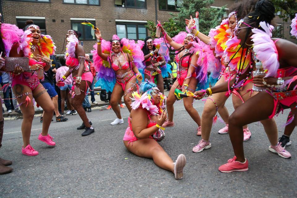  Dancers dressed in pink feather outfits got into the swing of things on Monday