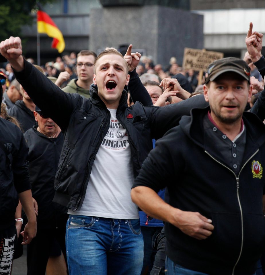  Far-right protesters demonstrate next to a sculpture of Karl Marx in Chemnitz