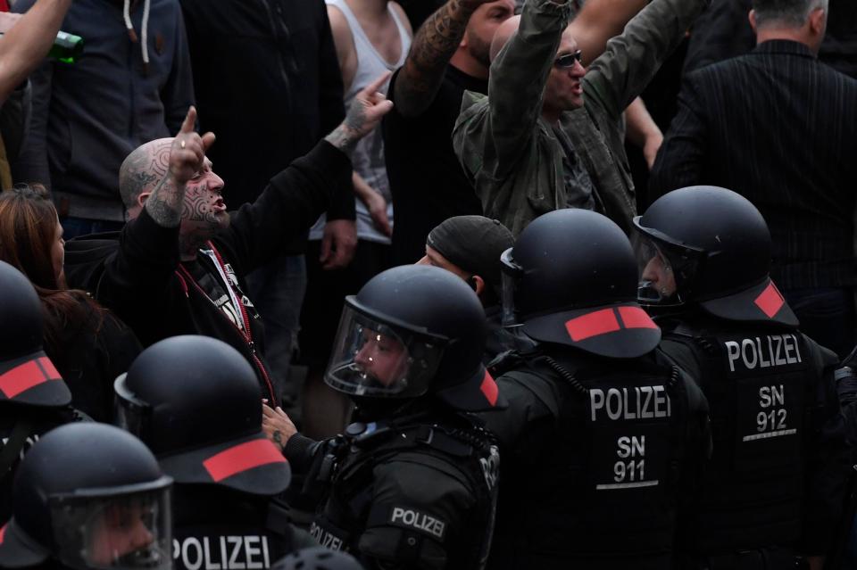  Angry far-right protesters confront riot police armed with batons in Chemnitz