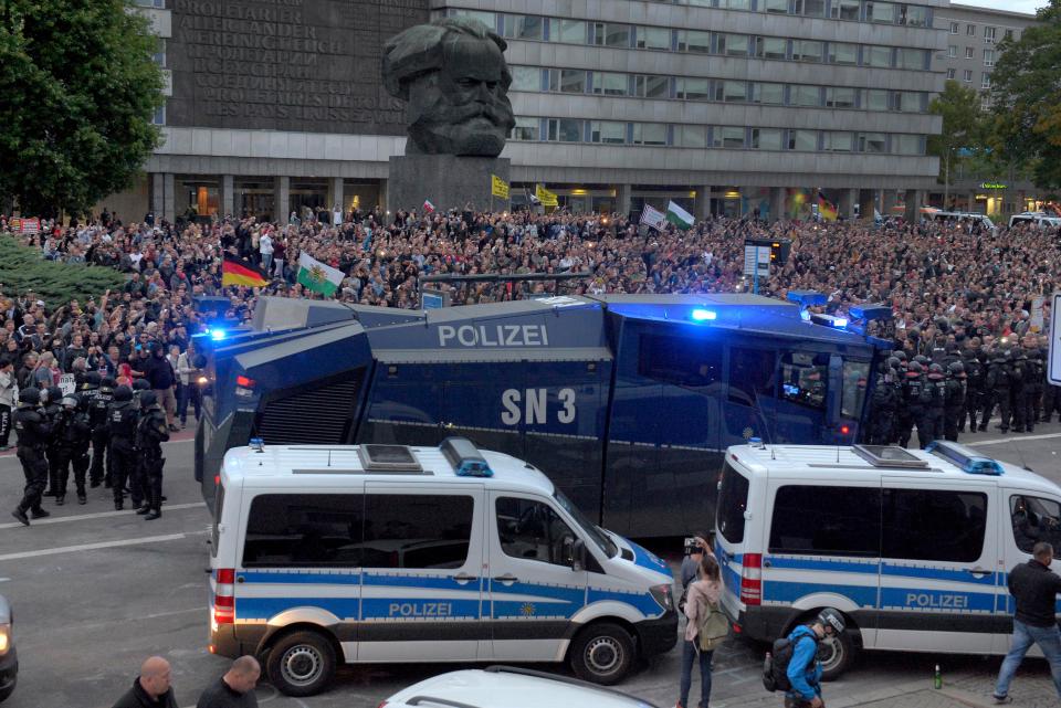  Police used water cannons as far-left and far-right groups threatened each other and pelted them with fireworks