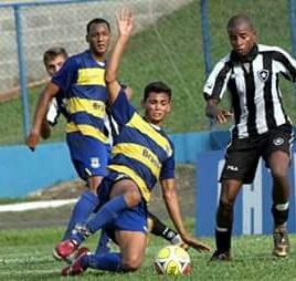 The midfielder, left, watches on as a team-mate slides in for the ball