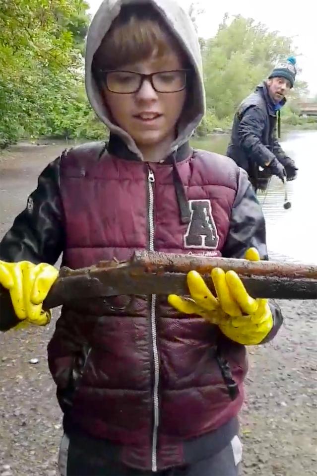  Youngster McKenzie handles the sawn-off shotgun, which he found magnet fishing at a canal in Oldbury, West Mids near to his home