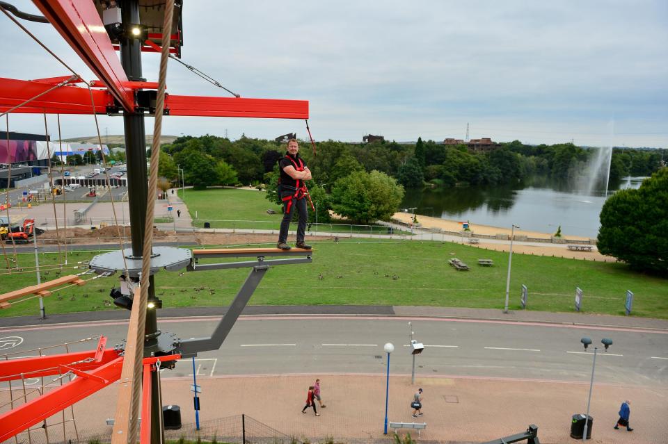  Brave Scott stands on the edge of rope obstacle course, which stands at 65ft