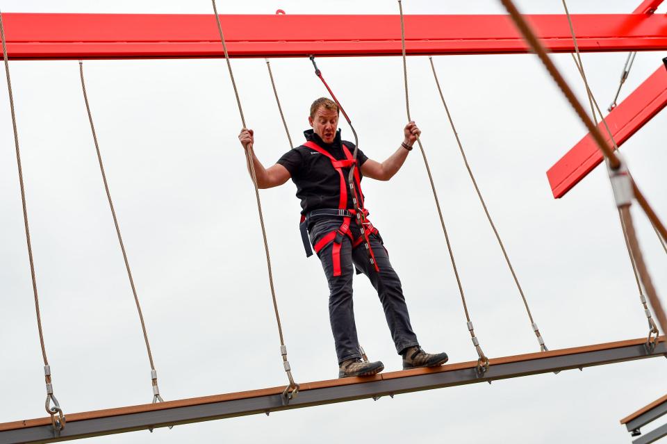  Bear Grylls' right-hand man, Scott Heffield, tries not to look down as the tries out the towering free-roam ropes