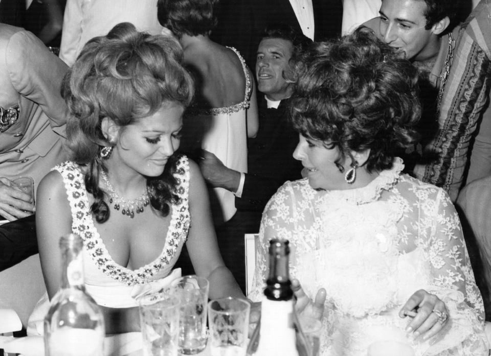  Film actress Elizabeth Taylor with Italian actress Claudia Cardinale at a charity ball in Venice in 1967