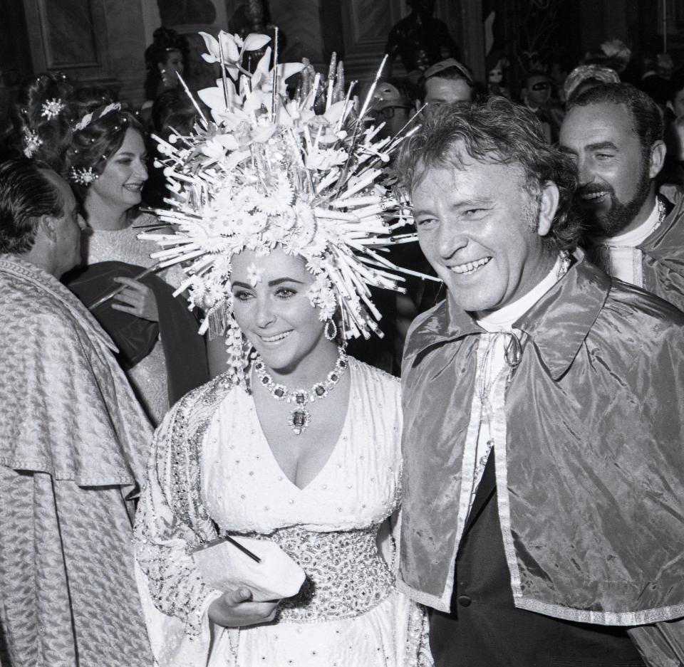  British-American actress Elizabeth Taylor with her husband Welsh actor Richard Burton at a masked ball at Ca' Rezzonico Palace, in Venice