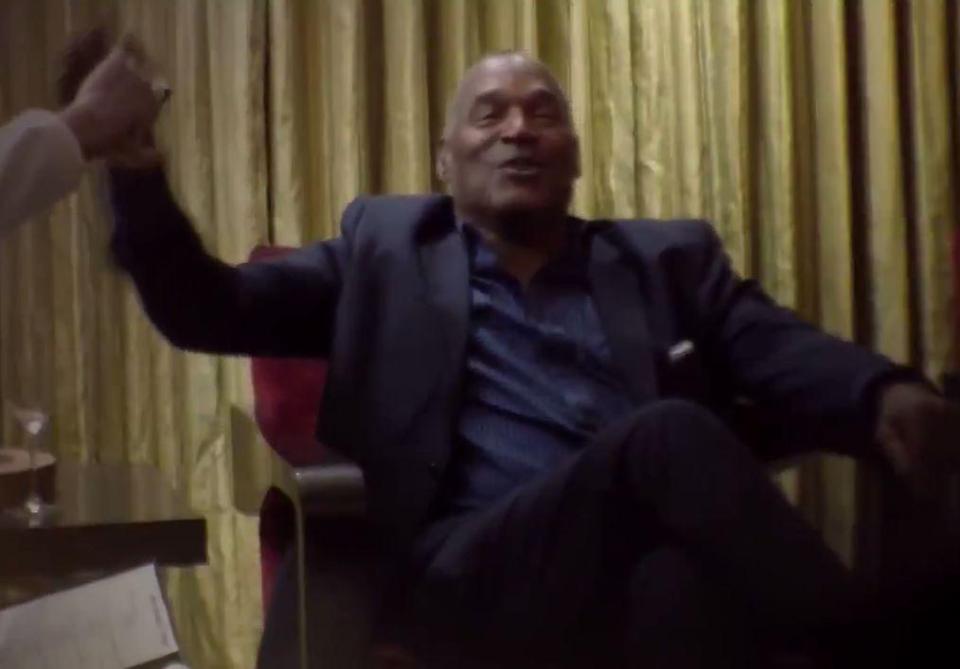  Sacha Baron Cohen's character high fives OJ Simpson as the pair chat in a hotel room