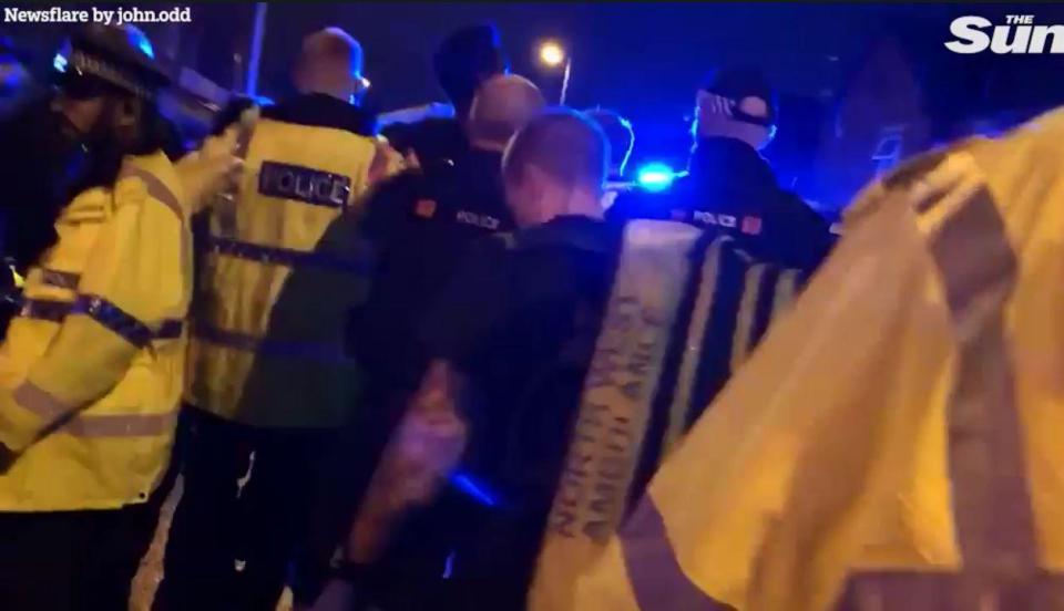  Footage shows police officers and paramedics leading a shooting victim to an ambulance