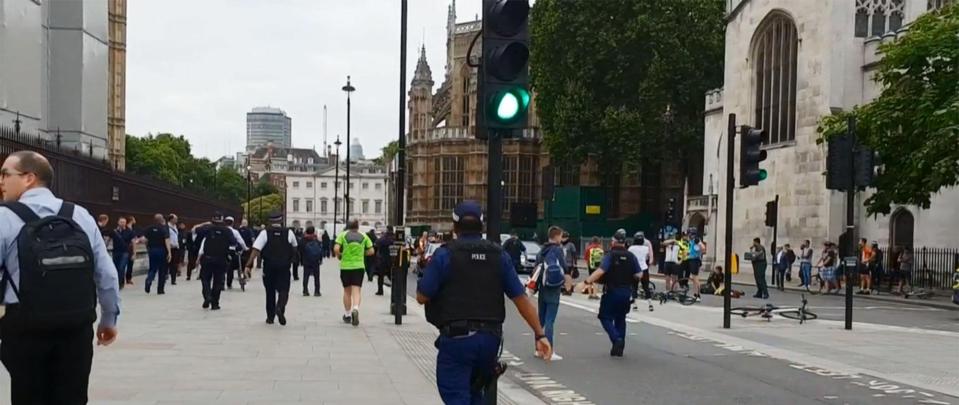  Terrified members of the public are lead away from Parliament Square by cops