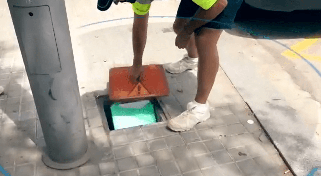  Police officers open drain covers to reveal the secret stashes hidden inside