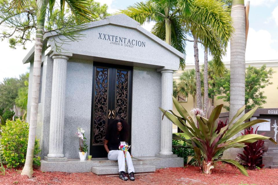  A fan sits outside the mausoleum where XXXTentacion is buried - but his sister has been told she is not allowed in