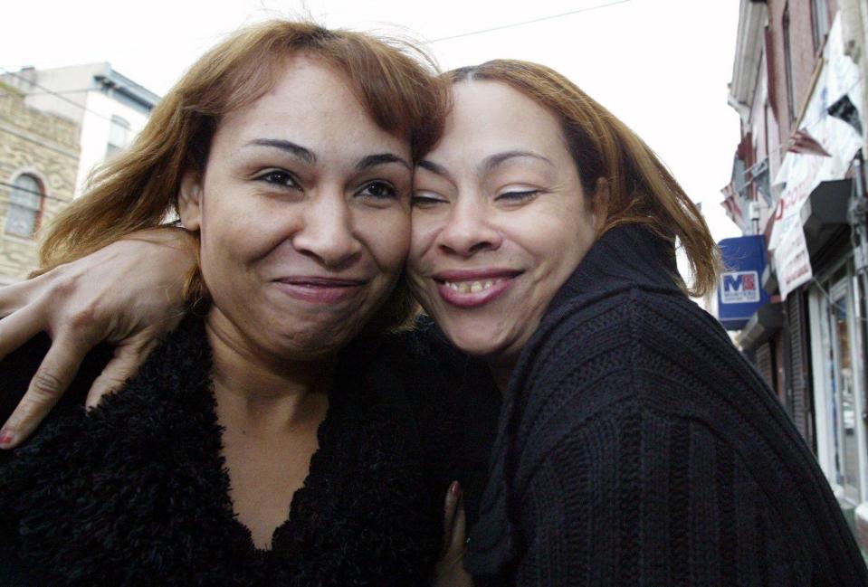  Luz Cuevas, left, gets a hug from her sister Luz de Jesus after tracking down her daughter