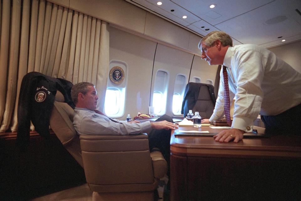  Bush confers with the White House Chief of Staff Andrew Card on Air Force One