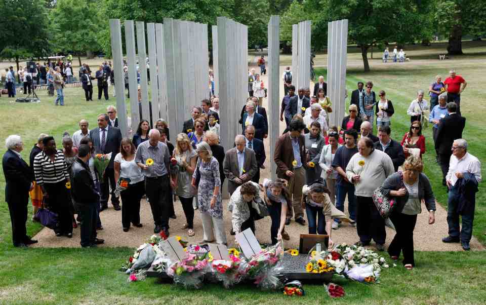 Visitors walk through the 52 steel pillars that make up the London Bombing Memorial in Hyde Park in London