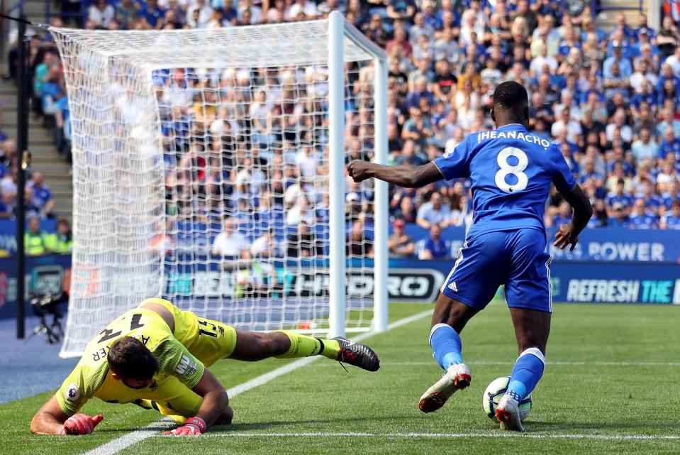  Alisson is tackled as he tries a Cryuff turn on Kelechi Iheanacho of Leicester