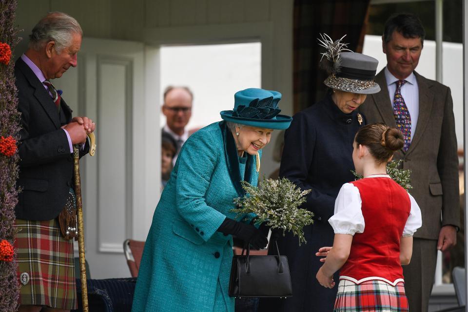  Her majesty was presented with a bunch of flowers by a Highland dancer at the games