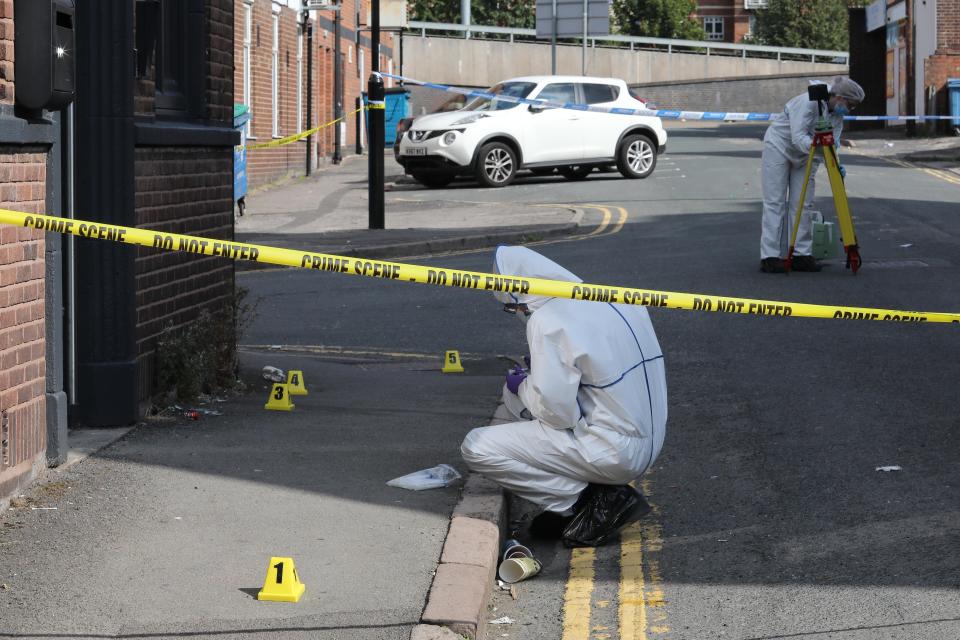  A forensic officer at the scene. A second man is in a serious but stable condition, police said