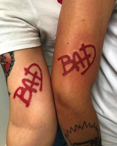  This couple got matching tattoos inspired by Michael Jackson's album cover font for Bad