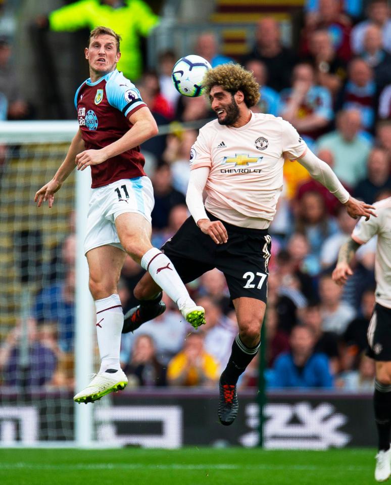  Fellaini leaps for a header with Burnley striker Chris Wood in the win at Turf Moor