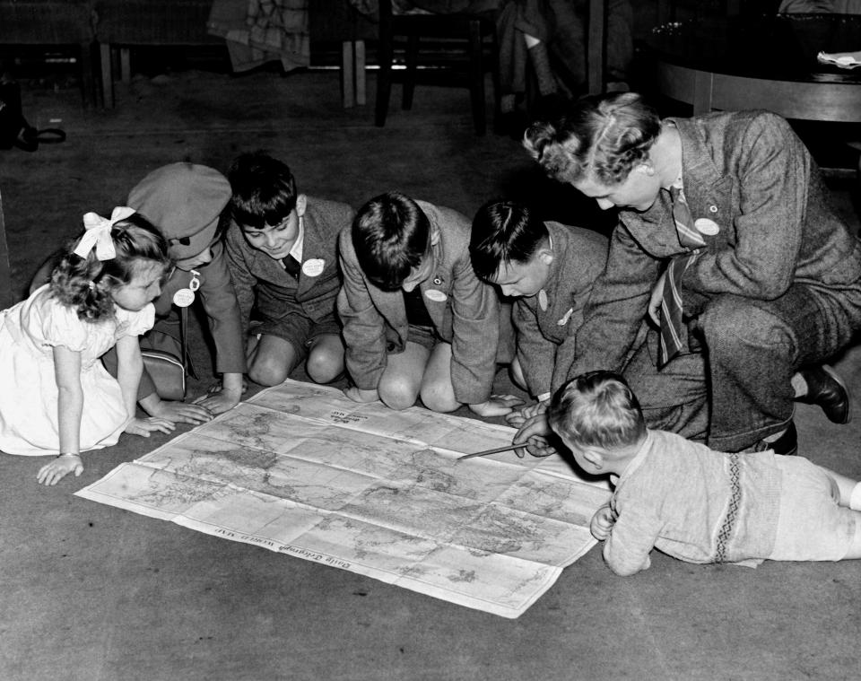  A group of children inspecting a map of Australia at Overseas House