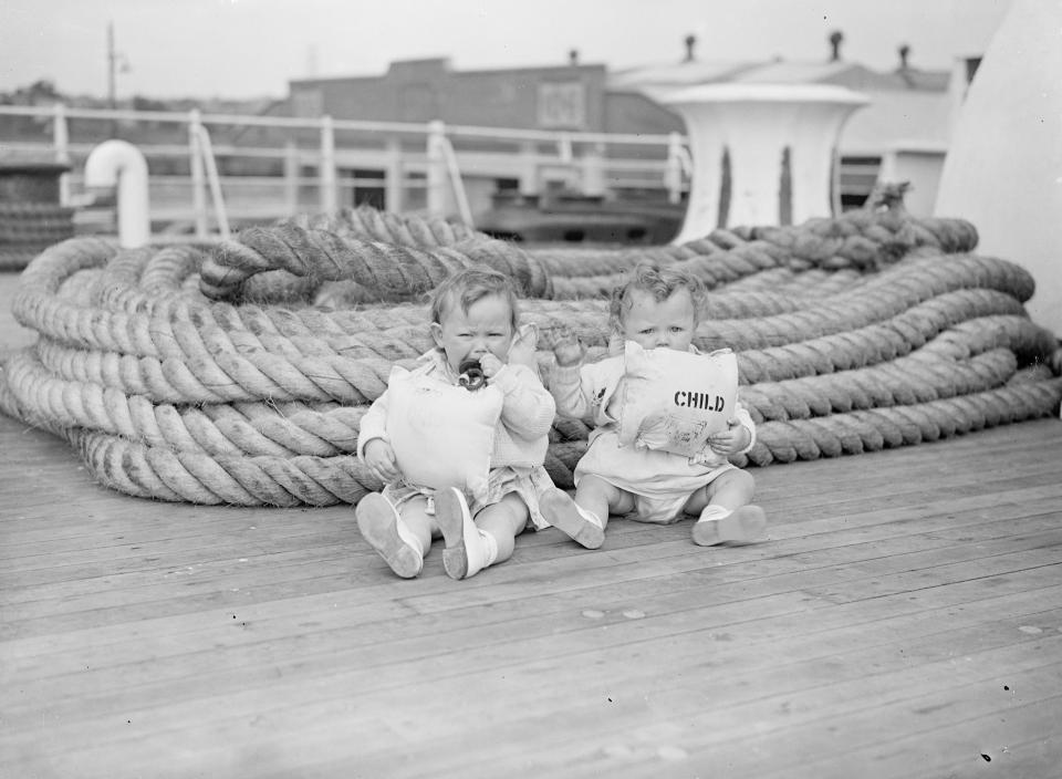  Two toddlers at the start of their journey to Canada on the SS. Aquitania