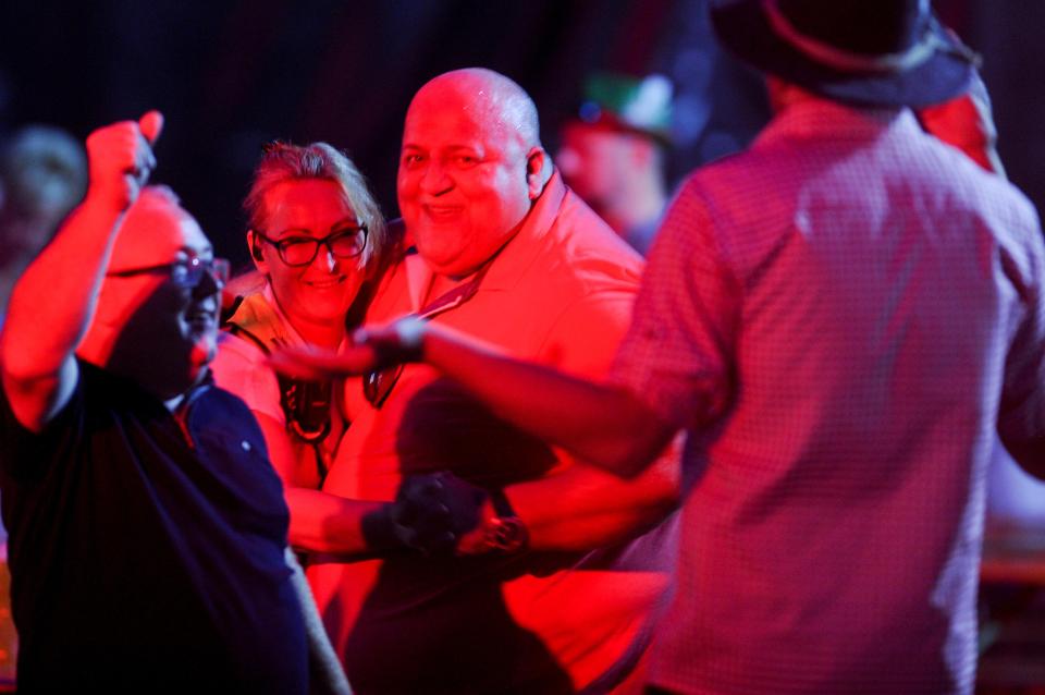  Adrian dances with a woman at the Oktoberfest event