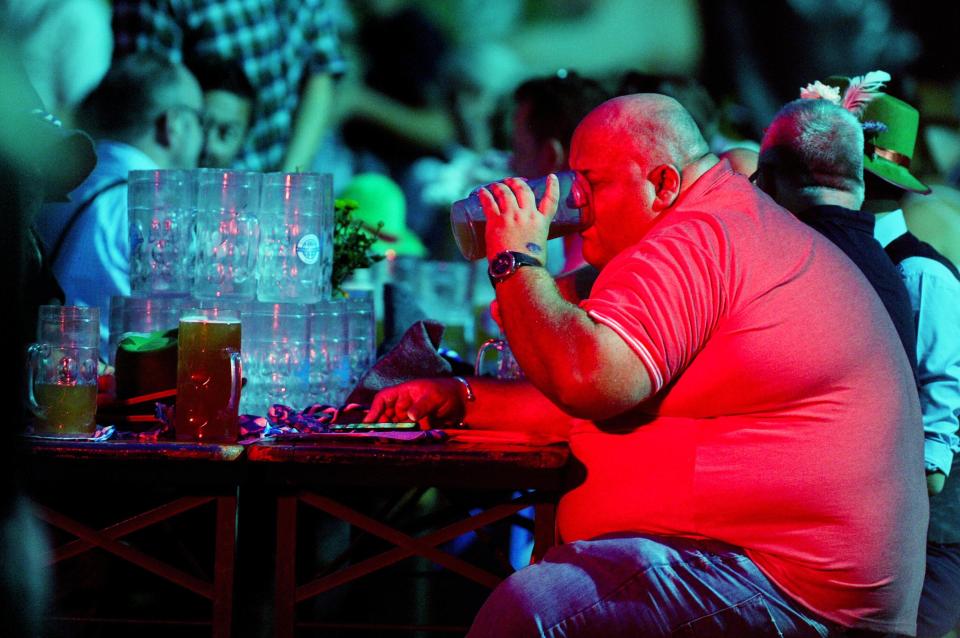  EuroMillions winner Adrian Bayford downs massive glasses of beer at an Oktoberfest event in Cambridge