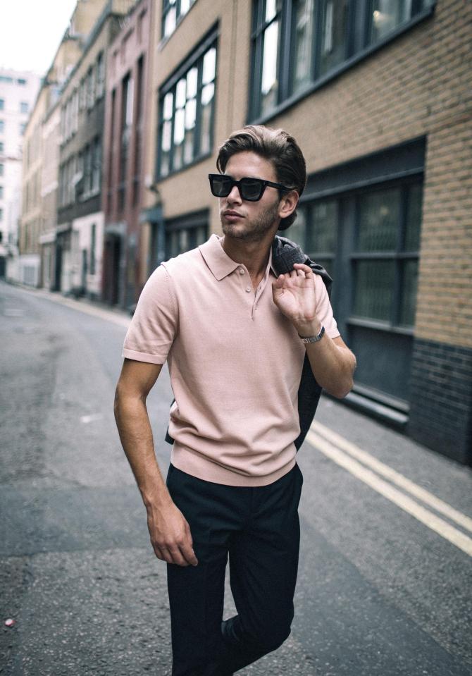 He later changed into a pale pink polo and shades for the shoot