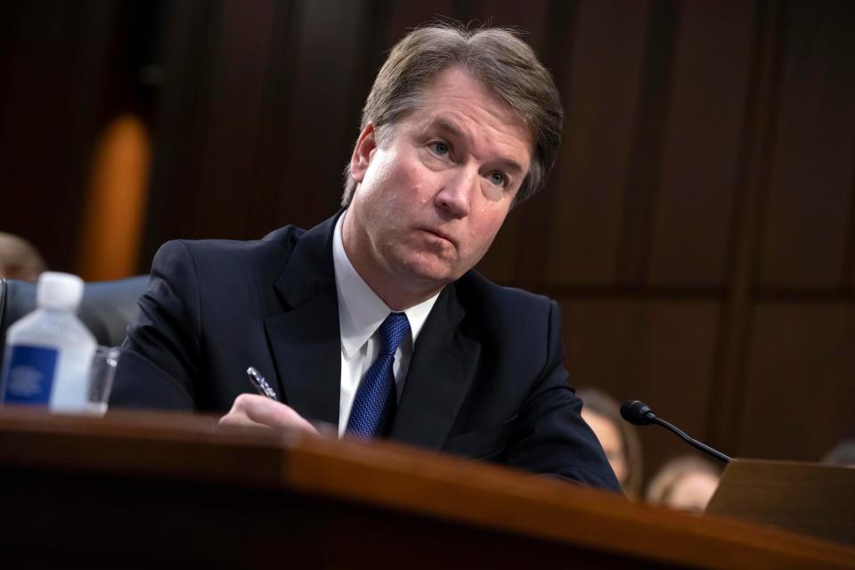  Brett Kavanaugh takes notes as the Senate Judiciary Committee members make opening statements during his confirmation hearing