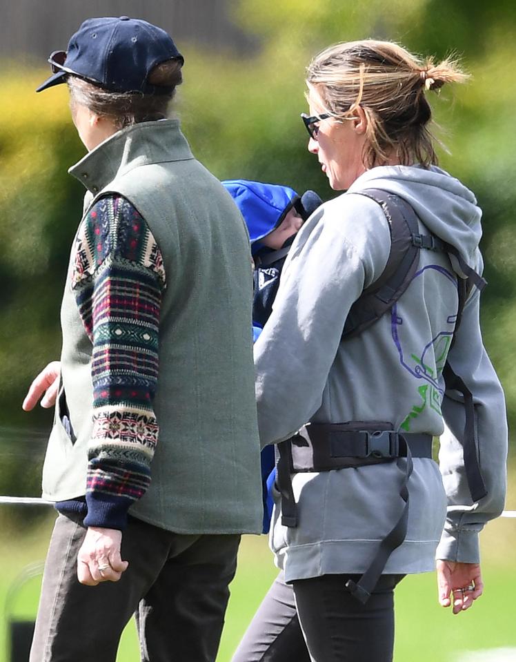  Little Lena was seen out and about in a blue babygrow as she was carried around by family friend, Dolly Maude