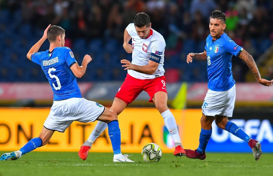  Italy midfielder Jorginho takes on Poland's striking legend Robert Lewandowski