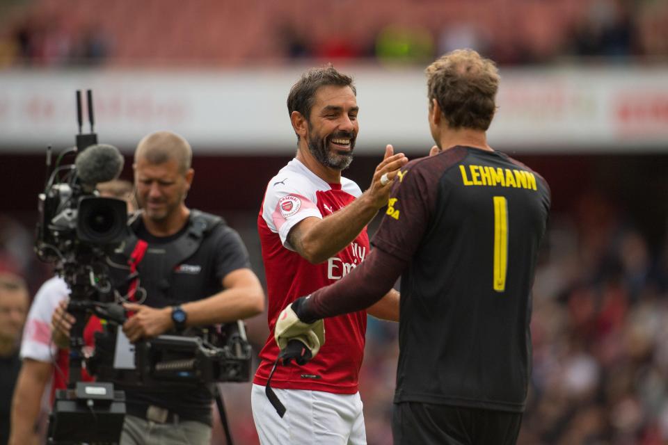  Robert Pires congratulates teammate Jens Lehmann at the final whistle of the Legends match.