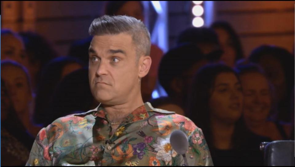  Robbie Williams was caught ogling a busty contestant on the X Factor