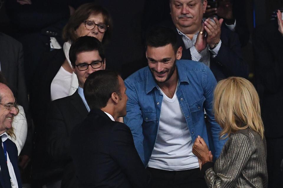 Hugo Lloris shakes hands with French president Emmanuel Macron during the game